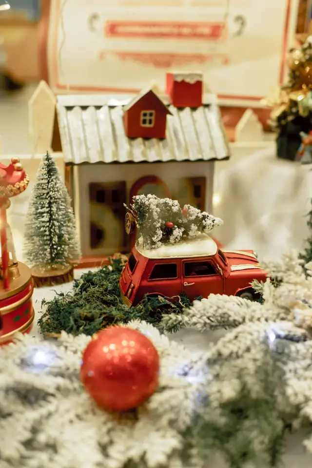 A small frosted bottle-brush tree in a holiday scene